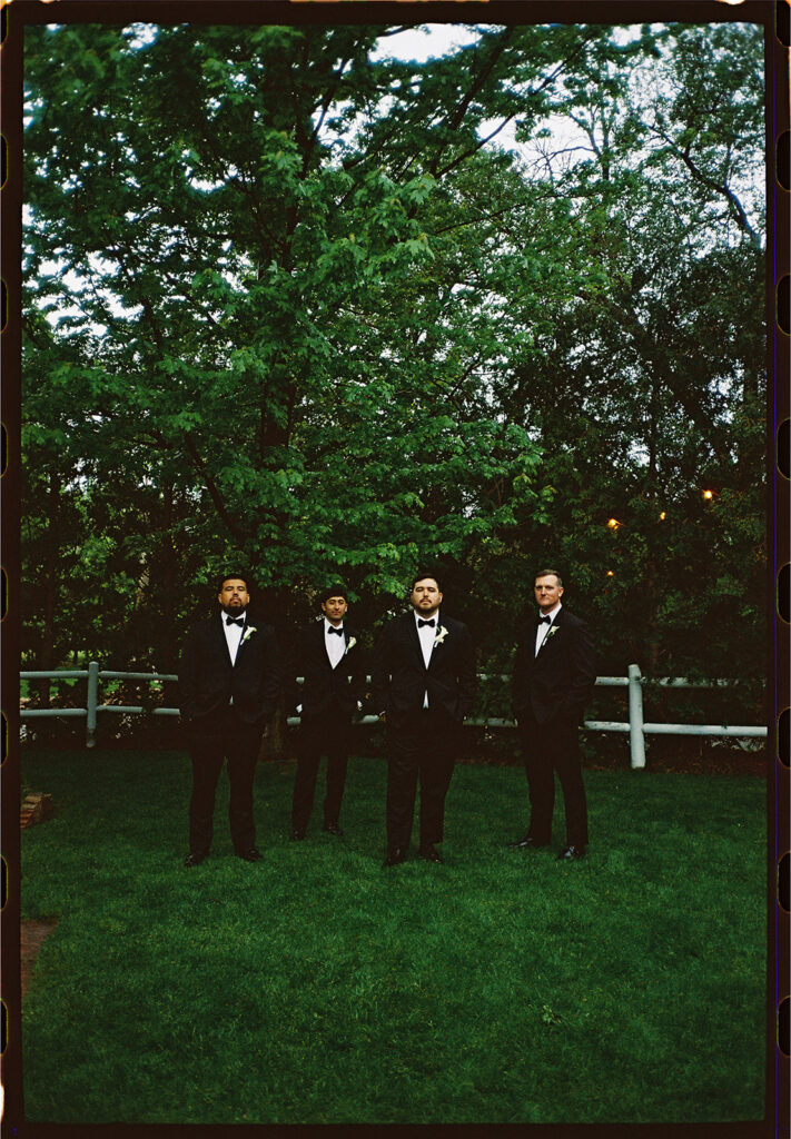 candid moment of the groom and groomsmen in green briar inn wedding 