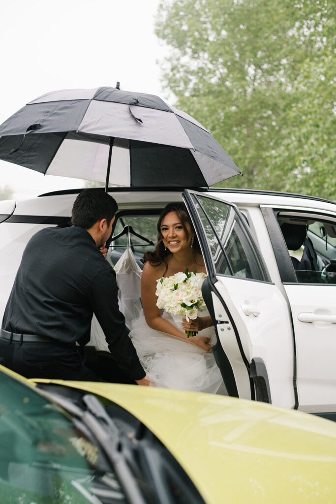 Bride and groom laughing together during their rainy Greenbriar Inn wedding.
