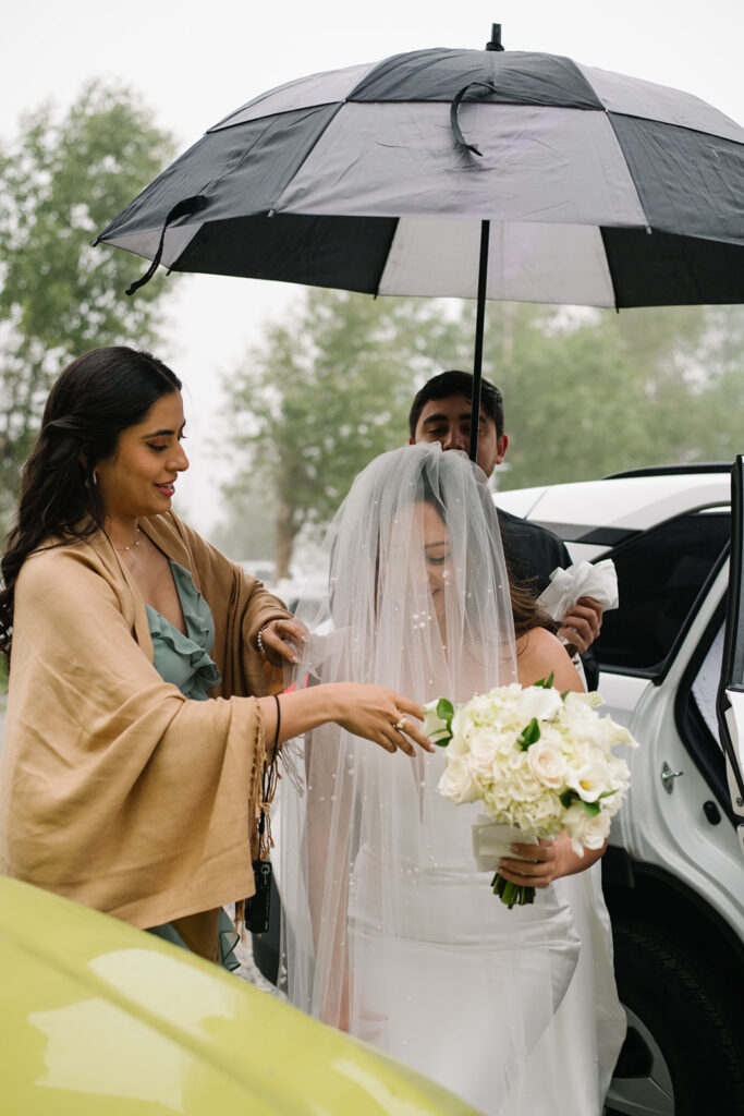 Bride and groom laughing together during their rainy Greenbriar Inn wedding.