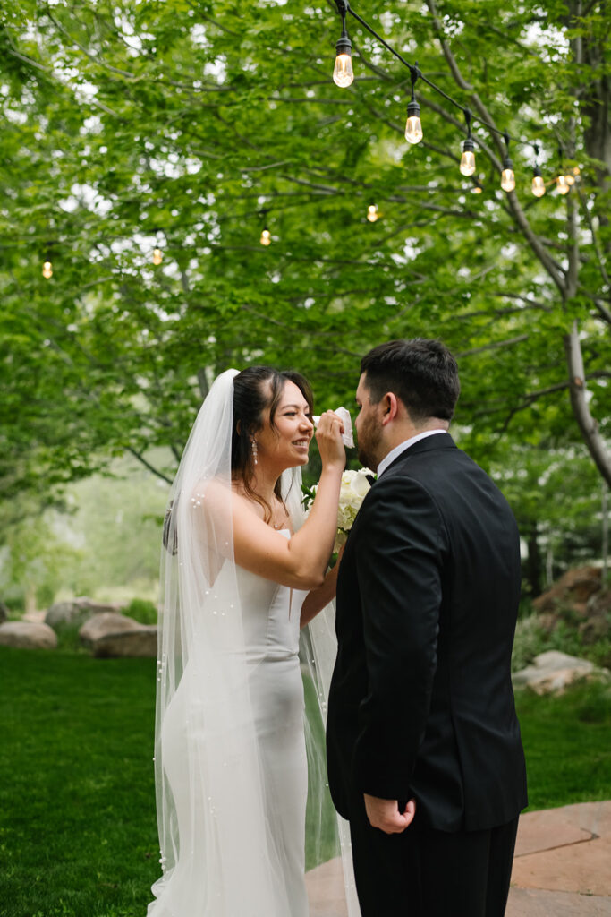 Bride and groom laughing together during their rainy Greenbriar Inn wedding.