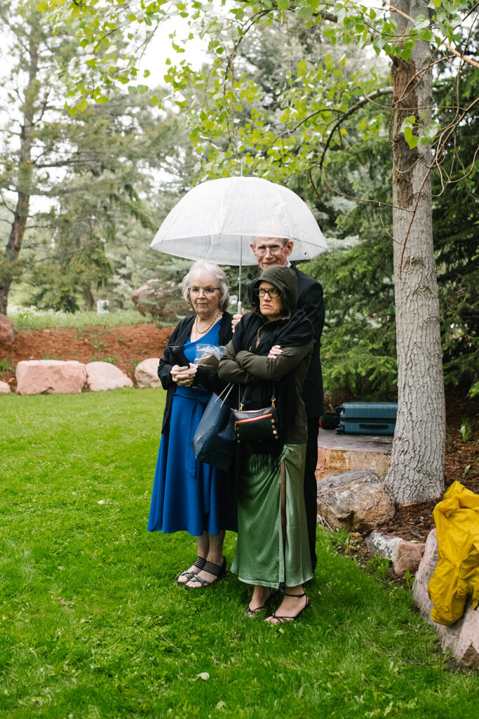 Rainy spring Greenbriar Inn wedding ceremony with guests under umbrellas.