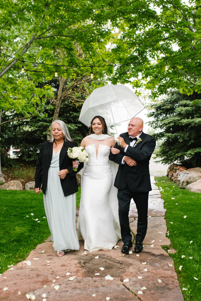 bride walking down the aisle at Greenbriar Falls wedding venue in boulder colorado