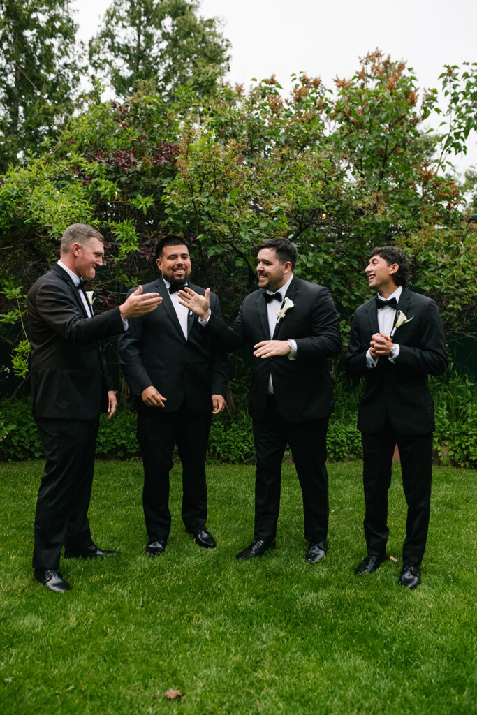 candid moment of the groom and groomsmen in green briar inn wedding 