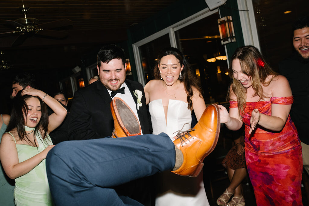 Friends laughing and enjoying the music at a Greenbriar Inn wedding reception.