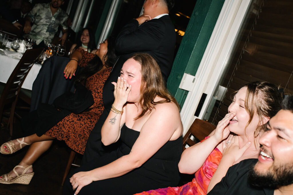 Friends laughing and enjoying the music at a Greenbriar Inn wedding reception.