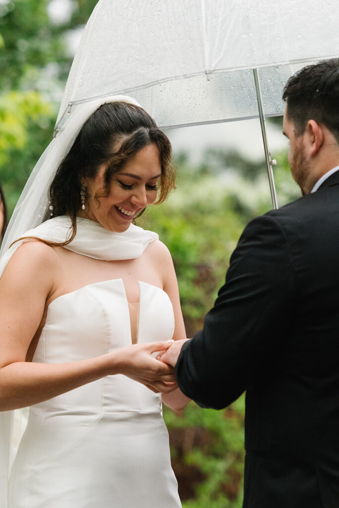 Rainy spring Greenbriar Inn wedding ceremony with guests under umbrellas.