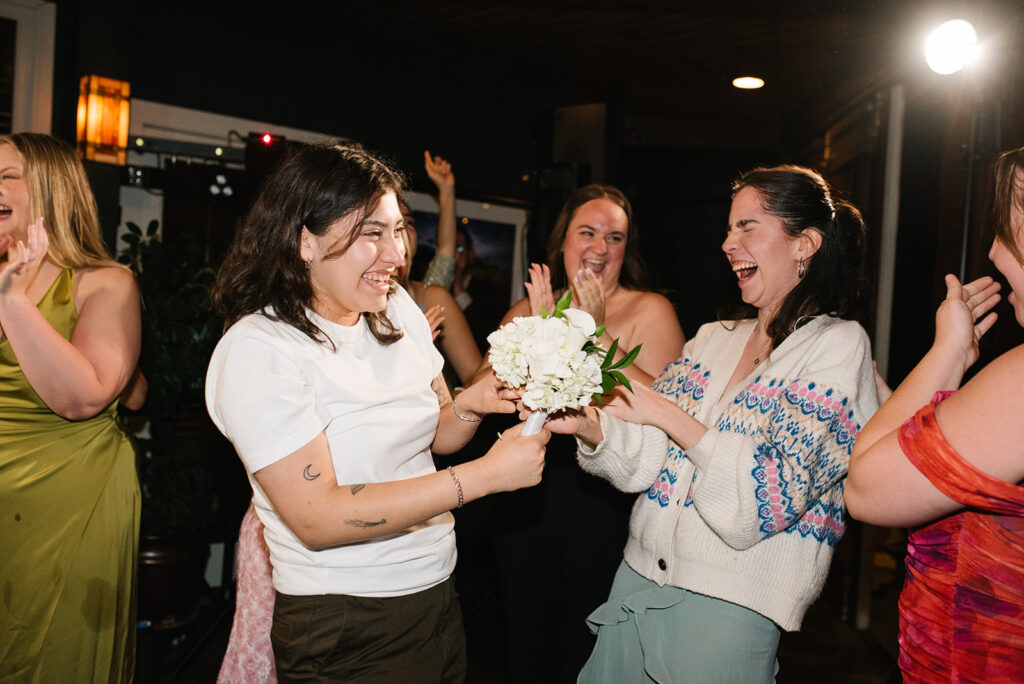 Friends laughing and enjoying the music at a Greenbriar Inn wedding reception.
