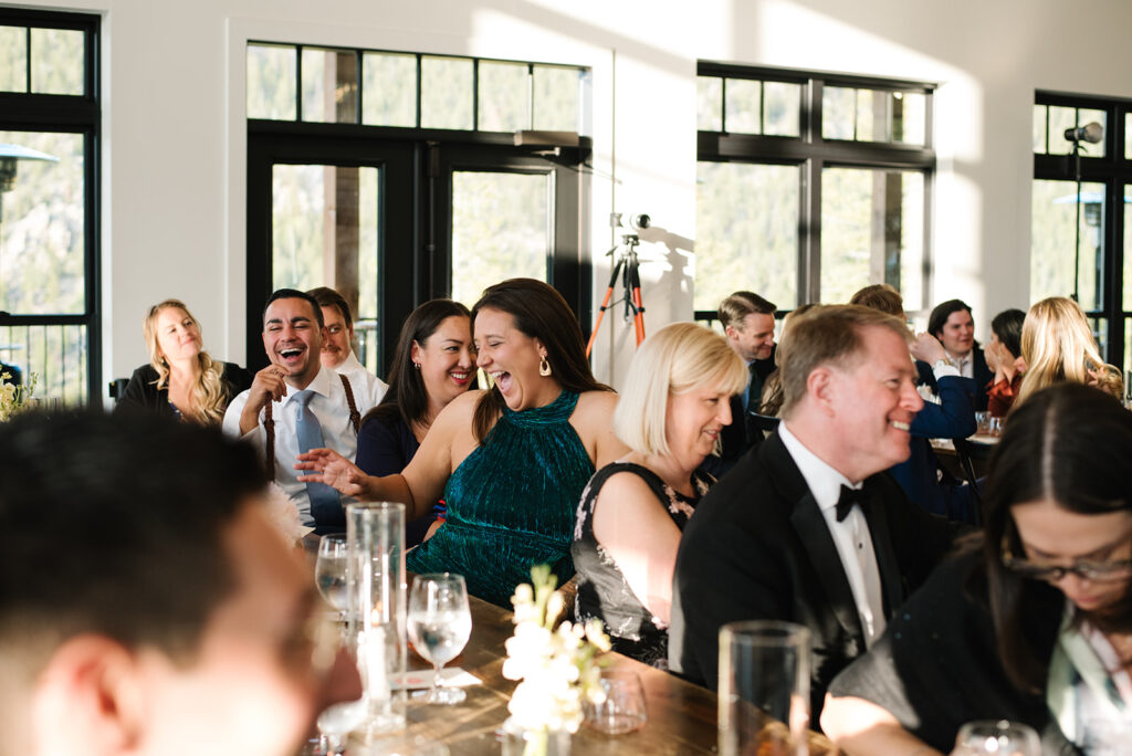 Candid laughter between friends during North Star Gatherings cocktail hour.