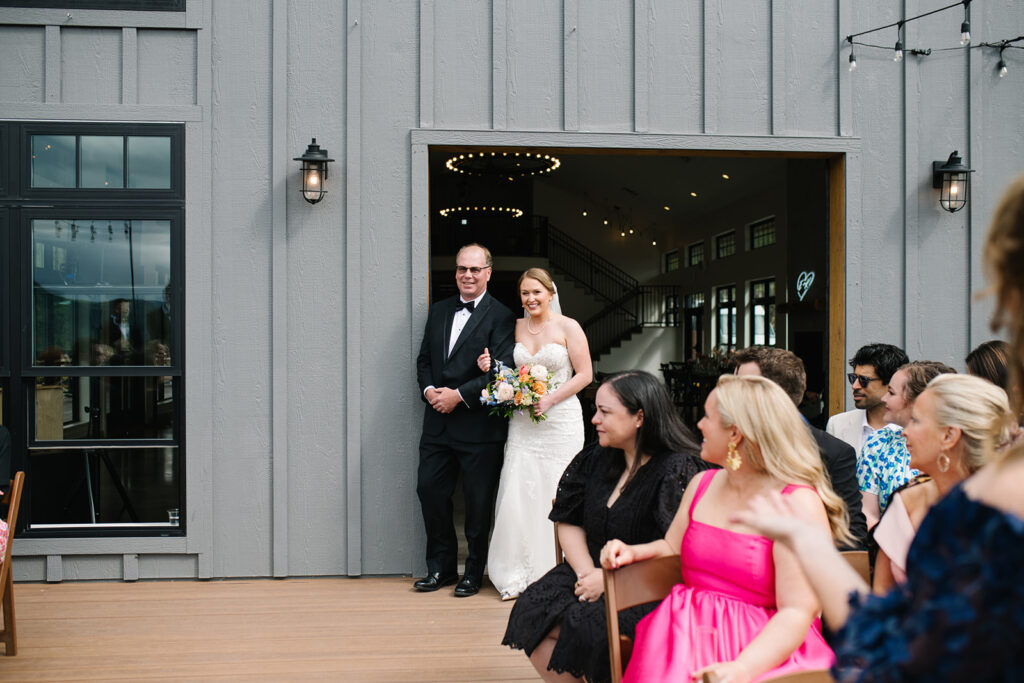 Bride walking down the aisle during outdoor ceremony at North Star Gatherings wedding venue.