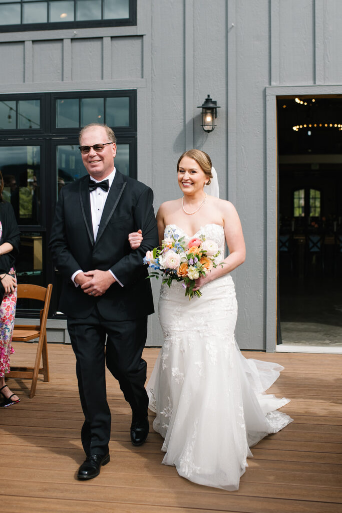 Bride walking down the aisle during outdoor ceremony at North Star Gatherings wedding venue.