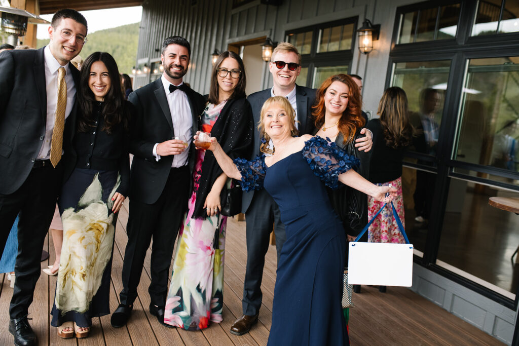 Guests mingling during cocktail hour at North Star Gatherings wedding deck.
