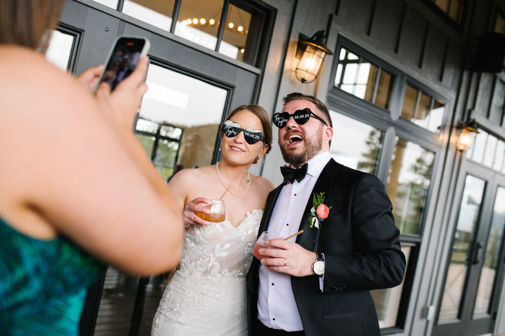 Guests clinking glasses during North Star Gatherings wedding toast.