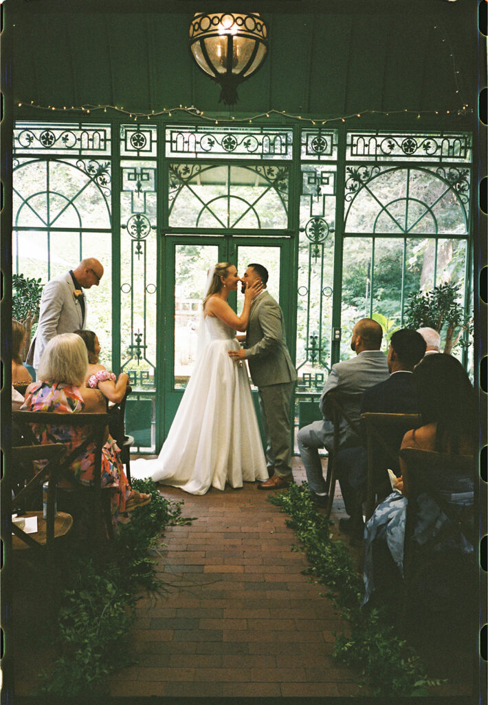 intimate and candid moments of guests at a ceremony taking place at the Mosaic Solarium in the Denver Botanic Gardens