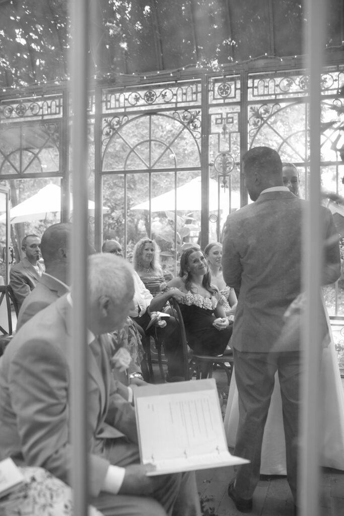 intimate and candid moments of guests at a ceremony taking place at the Mosaic Solarium in the Denver Botanic Gardens