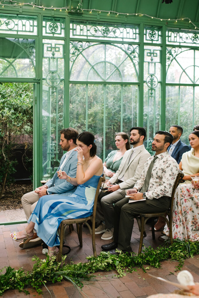 intimate and candid moments of guests at a ceremony taking place at the Mosaic Solarium in the Denver Botanic Gardens