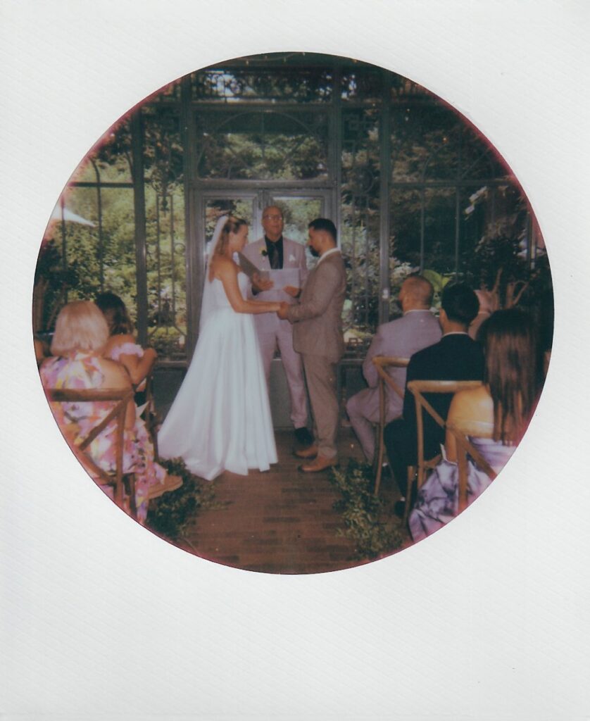 A ceremony taking place at the Mosaic Solarium in the Denver Botanic Gardens by a documentary wedding photographer